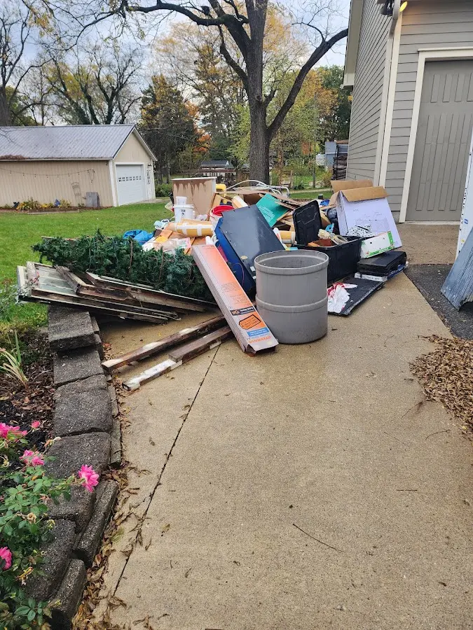 Dumpster being loaded with debris for Commercial Dumpster Rental in Reynolds
